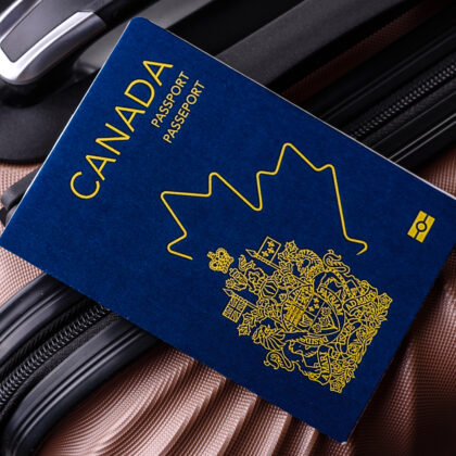 International passport of a citizen of Canada on a suitcase, departure from the airport, international travel